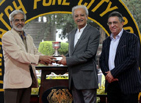Senior racing journalist Usman Rangeela presenting the Four Estate Trophy to Jaydev M Mody whose ward Transcend won this event at Pune on Saturday.
