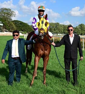 Mandolin (S Sachin up), winner of the S.M.ATTAOLLAHI MEMORIAL TROPHY being led in by trainer Helleal Moses R on Wednesday races at Mysore.