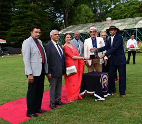 Sagar Muthappa and Kavitha Muthappa presenting the Sharan Lakshmanan Trophy to K K Belliappa after his ward won the event at Mysore on Saturday.