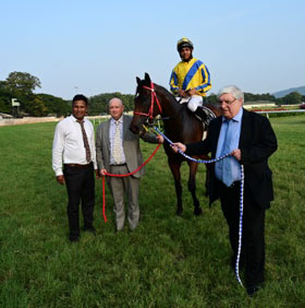 James McKeown, deputising for trainer S Padmanabhan and Firoze Vazifdar leading in Mystikos (Vivek G up), winner of Madras Race Club Trophy at Mysore on Sunday.