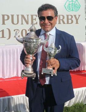 Sarosh Mody holding the HPSL Pune Derby trophy. Manjri Stud Farm bred Redefined won this event at  Pune on Sunday. Photo credit Amit gupta.