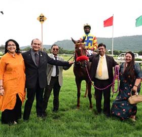 Dr Vijaya Sinha Doreswamy and trainer Rakesh leading in Pretty Move (Anthony Raj up), winner of Star of Mysore Trophy at Mysore on Thursday.